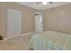 Bedroom featuring double doors and neutral walls at 4670 Links Village Dr # A506, Ponce Inlet, FL 32127