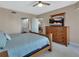 Warm and inviting bedroom offering a ceiling fan, tv and view to the en suite bathroom at 4670 Links Village Dr # A506, Ponce Inlet, FL 32127