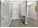 Entryway view with front door, console table, gray wood-look flooring, and neutral paint at 4670 Links Village Dr # A506, Ponce Inlet, FL 32127