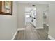 Hallway view into bright white kitchen with gray wood-look flooring and neutral paint at 4670 Links Village Dr # A506, Ponce Inlet, FL 32127