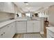 Modern kitchen with white cabinets, sleek appliances, and an open layout at 4670 Links Village Dr # A506, Ponce Inlet, FL 32127