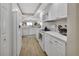 Well-equipped kitchen with bright white cabinets and modern appliances at 4670 Links Village Dr # A506, Ponce Inlet, FL 32127