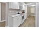 Well-equipped kitchen with bright white cabinets and modern appliances at 4670 Links Village Dr # A506, Ponce Inlet, FL 32127