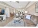 Living room with two sofas, marble coffee table, and view into the kitchen and dining areas at 4670 Links Village Dr # A506, Ponce Inlet, FL 32127