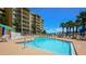 Stunning pool area with lounge chairs and an ocean view for relaxation at 4670 Links Village Dr # A506, Ponce Inlet, FL 32127