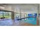 Bright indoor swimming pool with lovely mural and view of the lawn outside at 4670 Links Village Dr # A506, Ponce Inlet, FL 32127