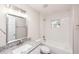 Bright bathroom with decorative mirror, granite countertop and combo shower-tub at 495 6Th St, Holly Hill, FL 32117