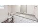 Clean bathroom with white vanity, granite countertop, and tiled shower at 495 6Th St, Holly Hill, FL 32117