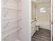 Bathroom featuring a bath, white tiling, modern toilet and cabinets at 495 6Th St, Holly Hill, FL 32117