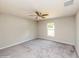 Comfortable bedroom with neutral carpet, ceiling fan, and a bright window at 495 6Th St, Holly Hill, FL 32117