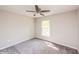A light and airy bedroom featuring neutral walls, carpet and a ceiling fan at 495 6Th St, Holly Hill, FL 32117