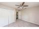 Cozy bedroom with a ceiling fan, carpet, and closet space at 495 6Th St, Holly Hill, FL 32117