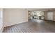 Open-concept living room and kitchen with modern gray wood floors and white cabinets at 495 6Th St, Holly Hill, FL 32117