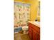 Bright bathroom featuring a vanity with a tan countertop and decorative beach-themed shower curtain at 522 Grace Ave, Deland, FL 32724