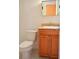 Compact bathroom featuring wood vanity with sink and modern faucet, as well as a toilet at 522 Grace Ave, Deland, FL 32724