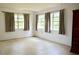 Large bright bedroom with three windows and modern curtains at 522 Grace Ave, Deland, FL 32724