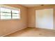 Bedroom featuring a window and a closet with standard sliding doors and neutral carpet at 522 Grace Ave, Deland, FL 32724