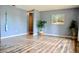 A bright living room with wooden floors, blue walls, and a tropical plant at 522 Grace Ave, Deland, FL 32724