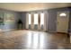 A living room with wood floors, blue walls, neutral curtains, and natural light at 522 Grace Ave, Deland, FL 32724