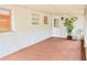 Enclosed porch area with white walls, tile floors, and a view of the backyard at 522 Grace Ave, Deland, FL 32724
