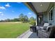 Relaxing back patio featuring comfortable chairs, fire pit and a scenic view of the golf course at 5430 Nw 35Th Lane Rd, Ocala, FL 34482
