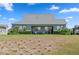 Backyard view features lawn, trimmed hedges, and outdoor seating area at 5430 Nw 35Th Lane Rd, Ocala, FL 34482