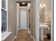 Hallway view into half bath featuring a stylish pedestal sink and tile flooring at 5430 Nw 35Th Lane Rd, Ocala, FL 34482