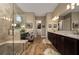 A spacious bathroom offers a dual sink vanity, glass shower, a vanity area, and a walk-in closet at 5430 Nw 35Th Lane Rd, Ocala, FL 34482