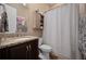 Bathroom featuring granite countertop, cabinet storage and shower with a stylish striped curtain at 5430 Nw 35Th Lane Rd, Ocala, FL 34482