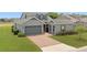 Charming home with a well-manicured lawn, brick driveway, and inviting curb appeal at 5430 Nw 35Th Lane Rd, Ocala, FL 34482