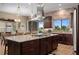 Kitchen island featuring granite countertops, seating, and a stainless steel refrigerator at 5430 Nw 35Th Lane Rd, Ocala, FL 34482