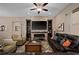 Inviting living room with a brick fireplace, sleek dark-wood shelving, and comfortable seating arrangement at 5430 Nw 35Th Lane Rd, Ocala, FL 34482