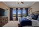 This is a main bedroom with an area rug and a king bed with a blue comforter at 5430 Nw 35Th Lane Rd, Ocala, FL 34482