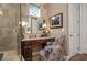 This bathroom has a vanity area with a granite countertop, a decorative chair, and a glass shower at 5430 Nw 35Th Lane Rd, Ocala, FL 34482