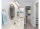 Bathroom featuring dual sinks, vanity countertop, updated fixtures, and convenient access to the bedroom at 576 Belltower Ave # 100, Deltona, FL 32725