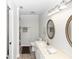 Bathroom showcasing a vanity with a sink, toilet, and mirror, all illuminated by modern lighting at 576 Belltower Ave # 100, Deltona, FL 32725