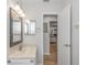 Bathroom with marble-look vanity, decorative mirror, and a doorway to other rooms at 576 Belltower Ave # 100, Deltona, FL 32725