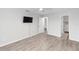 Relaxing bedroom with wood-look flooring, ceiling fan, and two entryways at 576 Belltower Ave # 100, Deltona, FL 32725