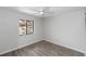 Bright bedroom with a modern ceiling fan, wood-look flooring, and a sunlit window at 576 Belltower Ave # 100, Deltona, FL 32725
