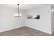 Dining room with modern light fixture, neutral walls, and wood-look floors at 576 Belltower Ave # 100, Deltona, FL 32725