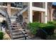 Building entrance with covered entryway, tiled porch and decor with stairs leading up to the next unit at 576 Belltower Ave # 100, Deltona, FL 32725