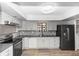 Modern kitchen featuring sleek black stainless appliances and light gray cabinets at 576 Belltower Ave # 100, Deltona, FL 32725
