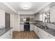 Well-lit kitchen with stainless steel appliances and wood-look floors, perfect for cooking at 576 Belltower Ave # 100, Deltona, FL 32725