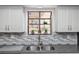 Kitchen sink area featuring decorative backsplash and plants in the window at 576 Belltower Ave # 100, Deltona, FL 32725