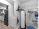 Functional laundry room with washer, dryer, shelves, and storage, conveniently located near the kitchen at 576 Belltower Ave # 100, Deltona, FL 32725