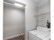 Bright laundry area with washer, storage closet, and overhead shelving at 576 Belltower Ave # 100, Deltona, FL 32725
