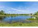 Scenic pond view with blue skies, wispy clouds, and lush green surroundings at 576 Belltower Ave # 100, Deltona, FL 32725