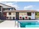 Side angle of community pool building with relaxing decor, bath house, rules and regulations, with pool in the front at 576 Belltower Ave # 100, Deltona, FL 32725