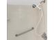 Shower space featuring tiled walls, a grab bar for safety, and an adjustable shower head at 576 Belltower Ave # 100, Deltona, FL 32725