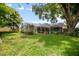 Backyard shot of the home and screened-in patio area, perfect for entertaining at 5776 White Acres Ln, Port Orange, FL 32127